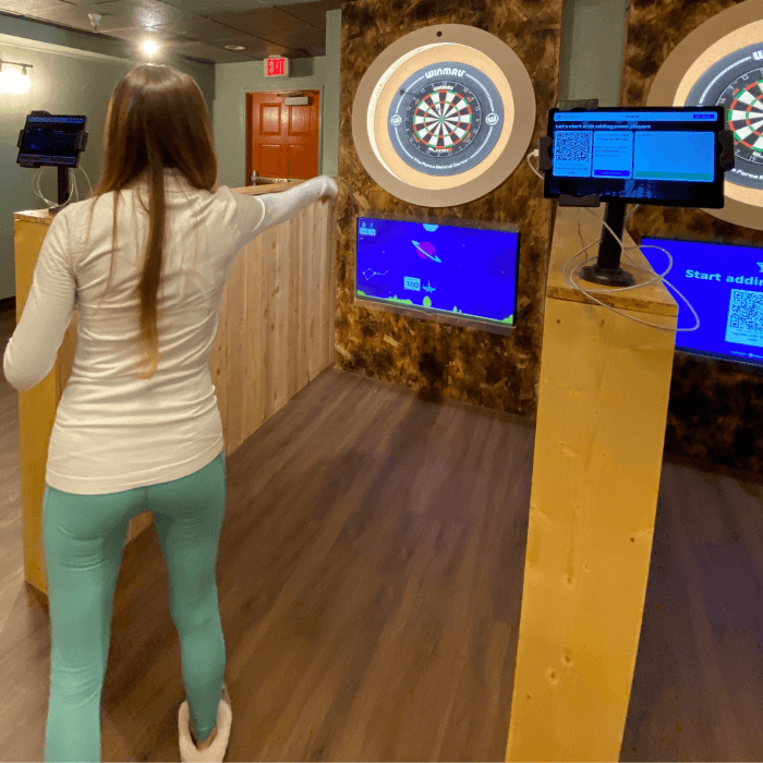 girl playing high tech darts
